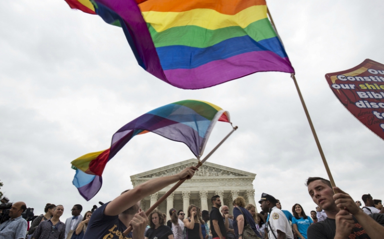 Supporters of gay marriage wave the rainbow flag after the U.S. Supreme Court ruled on June 26, 2015, that the U.S. Constitution provides same-sex couples the right to marry. (Courtesy of Reuters/Joshua Roberts)