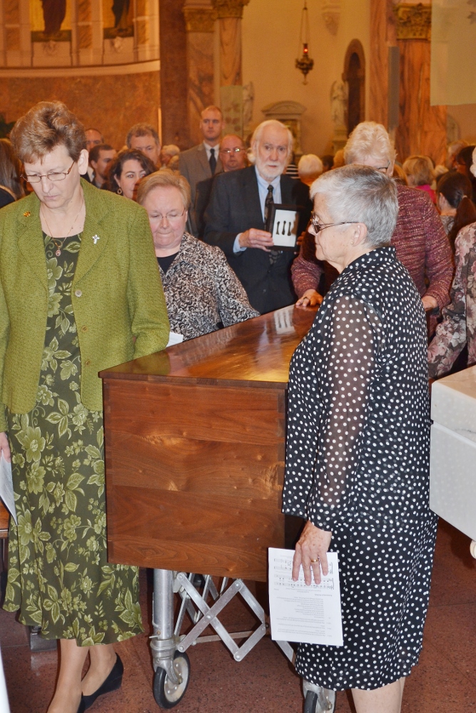 Clockwise from left, Srs. Dawn Tomaszewski, Mary Beth Klingel, Lisa Stallings and Denise Wilkinson, general superior, wheel the remains of St. Mother Theodore Guerin from the Church of the Immaculate Conception to her new permanent shrine. (Courtesy of Sisters of Providence of Saint Mary-of-the-Woods)