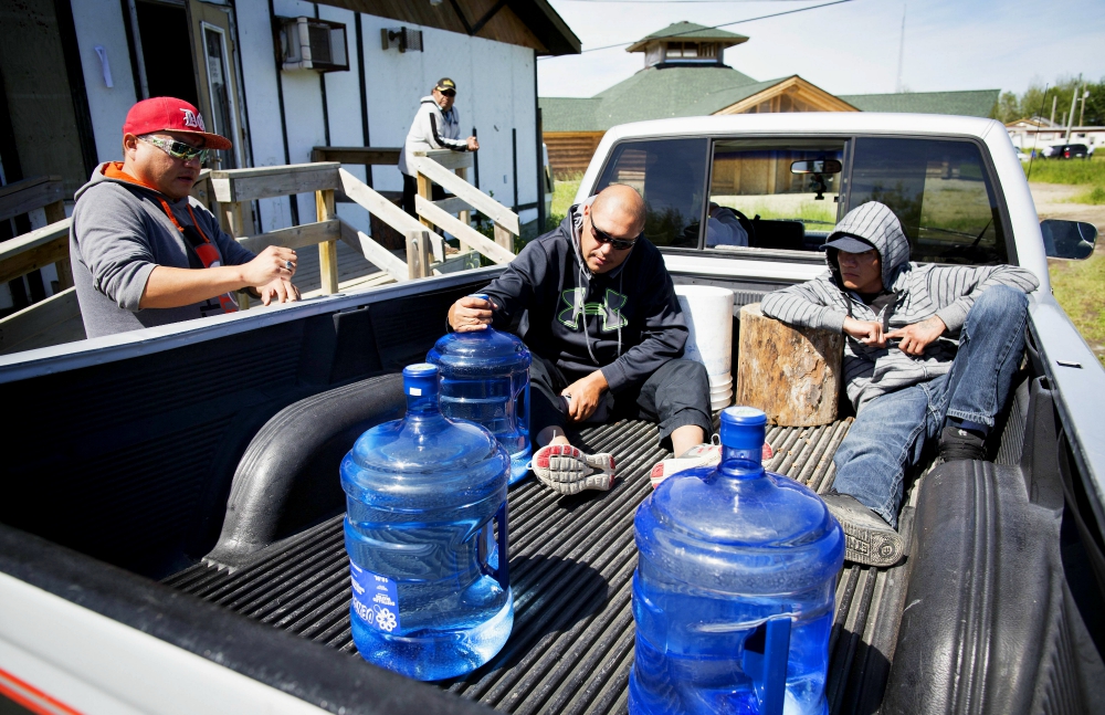 Members of the Grassy Narrows First Nation in Ontario, Canada, pick up their supply of drinking water. The Grassy Narrows water system is considered contaminated by mercury so local residents rely on bottled water. (Newscom / Toronto Star / Todd Korol)