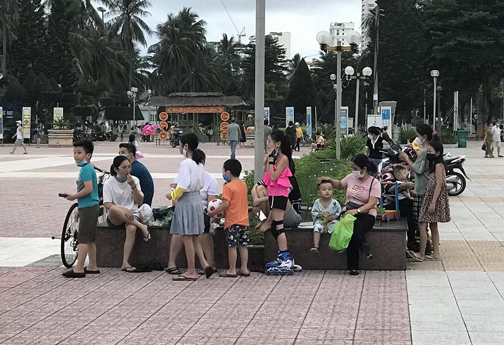 Children and their parents play in a park in Nha Trang, Vietnam, after a COVID-19 lockdown was lifted on Oct. 17. (Joachim Pham)