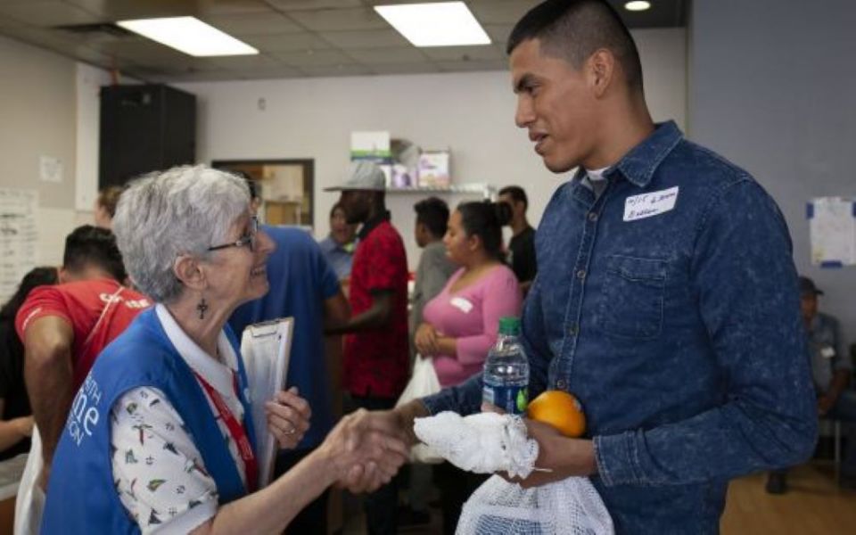 Presentation of the Blessed Virgin Mary Sr. Sharon Altendorf, left, says goodbye to Jader Reyes of Nicaragua, after she gave him food and mapped his travel itinerary on June 14, 2019. 