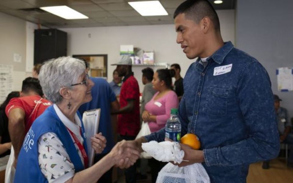 Presentation of the Blessed Virgin Mary Sr. Sharon Altendorf, left, says goodbye to Jader Reyes of Nicaragua, after she gave him food and mapped his travel itinerary on June 14, 2019.