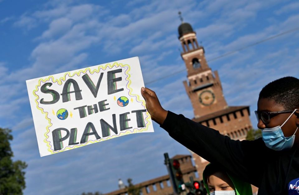 A demonstrator holds up a sign at an Oct. 1 Fridays for Future climate strike in Milan, Italy, ahead of the Oct. 31-Nov. 12 U.N. Climate Change Conference in Glasgow, Scotland. (CNS/Reuters/Flavio Lo Scalzo)