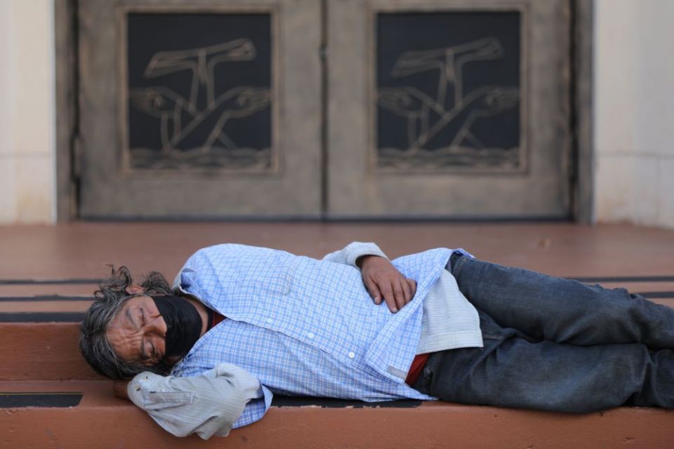 A homeless man sleeps outside Our Lady of Guadalupe Church in Austin, Texas, Sept. 3. (CNS/Bob Roller)