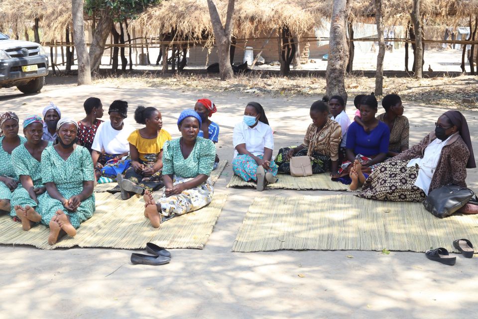 Srs. Marieta Makina (far right) and Patricia Chimimba (in floral skirt) sit with women from Eco Women Group. This nonprofit organization empowers women to save the environment in Kapiri, north of Malawi's capital, Lilongwe. (Doreen Ajiambo)