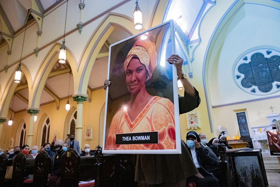 Theresa Wilson Favors, former director of the Office of Black Catholic Ministries for the Archdiocese of Baltimore, carries a portrait of Sr. Thea Bowman during an All Saints' Day Mass at St. Ann Catholic Church Nov. 1 in Baltimore. (CNS)
