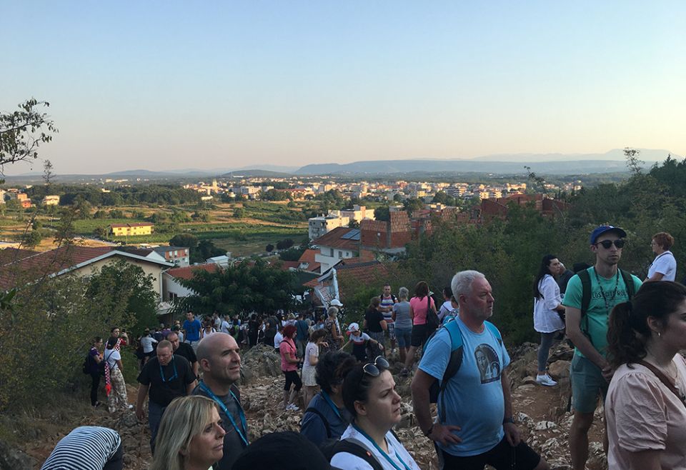 Pilgrims pray before a statue of Mary on Apparition Hill in Medjugorje, Bosnia-Herzegovina, in an August photo. (Kathryn Press) Pilgrims pray before a statue of Mary on Apparition Hill in Medjugorje, Bosnia-Herzegovina, in an August photo. (Kathryn Press)
