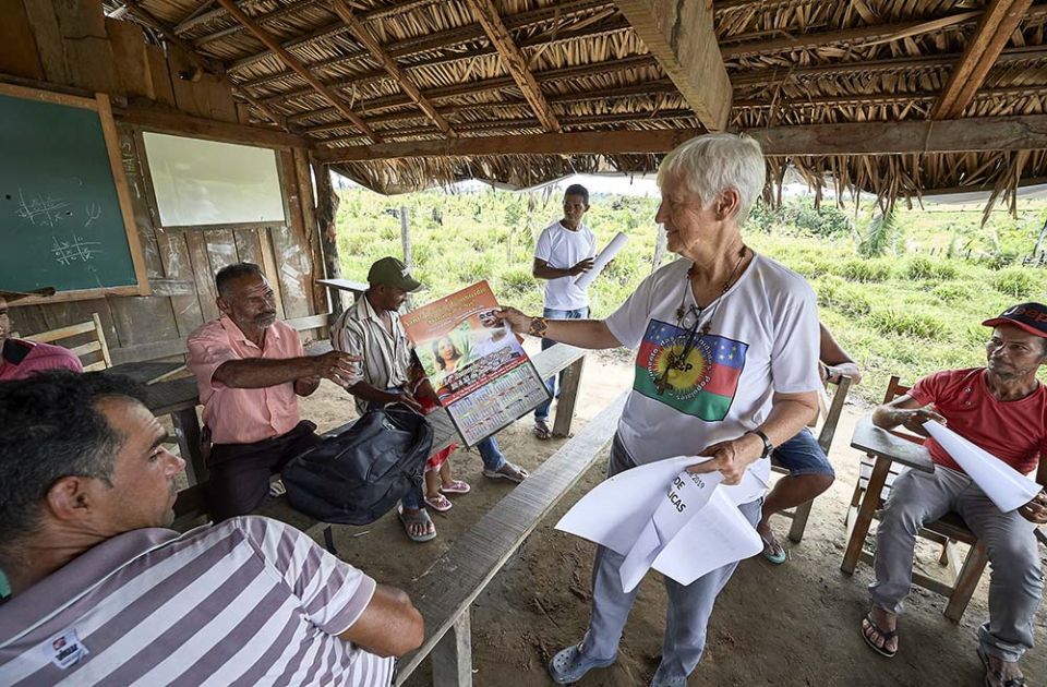 Notre Dame de Namur Sr. Kathryn "Katy" Webster hands out a calendar that promotes the Synod of Bishops for the Amazon to farmers in the countryside near Anapu, in Brazil's northern Para state, in April 2019. (CNS/Paul Jeffrey)