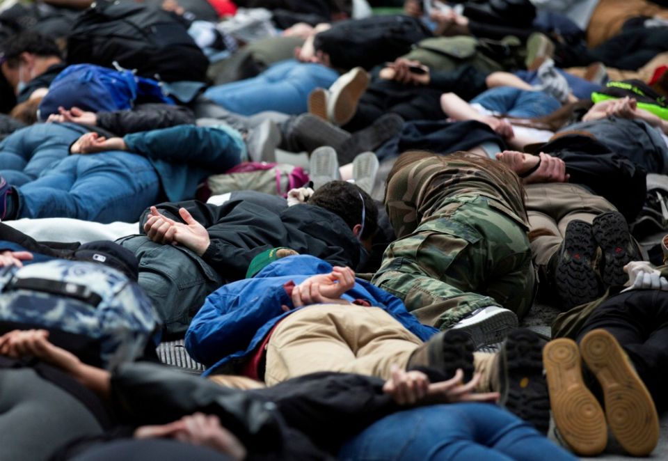 Protesters in Seattle lie down for a minute of silence June 2 in the position George Floyd was in when he died. (CNS/Reuters/Lindsey Wasson)
