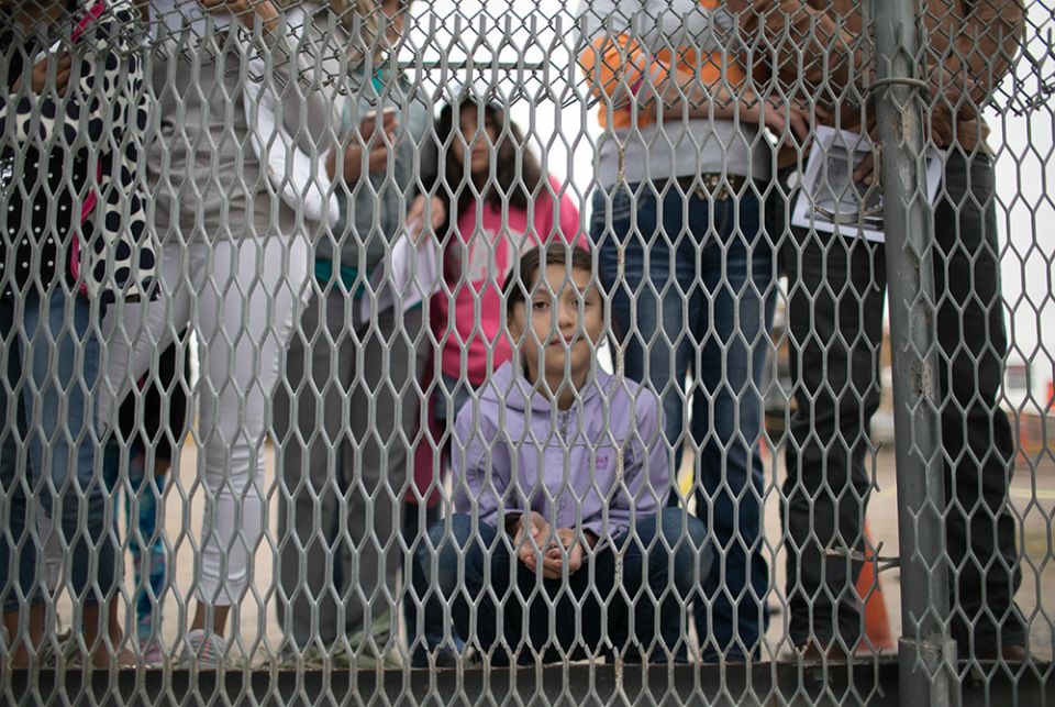 A little boy on the Mexican side of the border fence peers into in El Paso, Texas, on the U.S. side in this November 2017 photo. (CNS/Rich Kalonick, Courtesy of Catholic Extension)