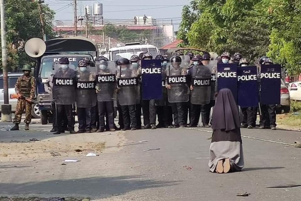 St. Francis Xavier Sr. Ann Nu Thawng kneels in front of police and soldiers during an anti-coup protest in Myitkyina, Myanmar, Feb. 28. (CNS/Courtesy of Myitkyina News Journal) St. Francis Xavier Sr. Ann Nu Thawng kneels in front of police and soldiers during an anti-coup protest in Myitkyina, Myanmar, Feb. 28, 2021.