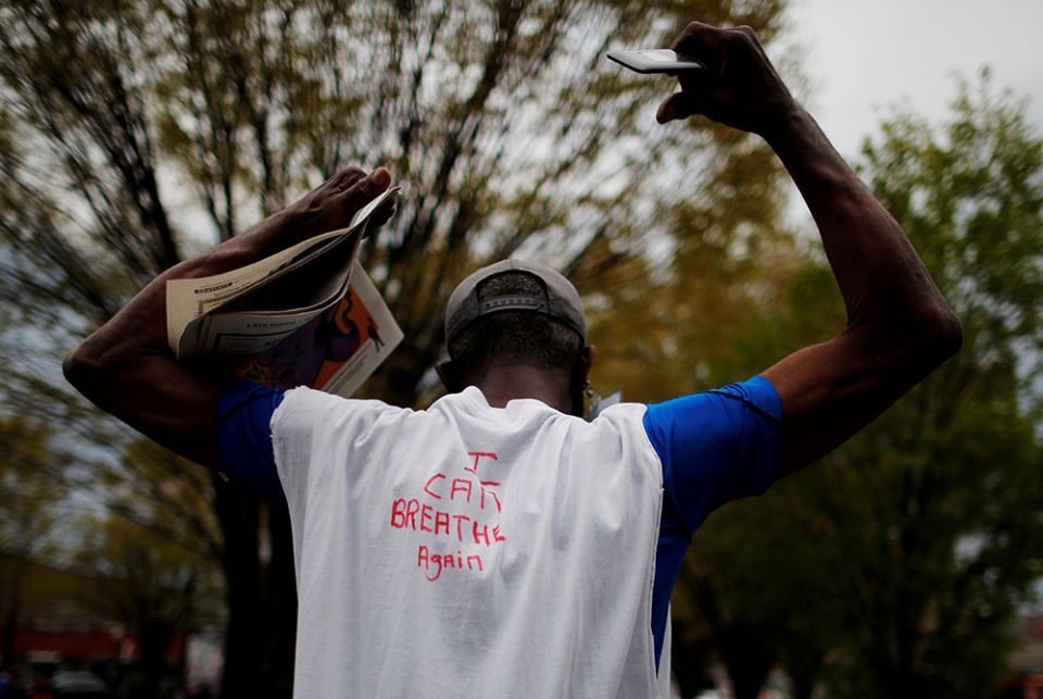 A man in Boston wears a hand-lettered T-shirt reading "I Can Breathe Again" at a demonstration April 21, 2021, one day after jurors convicted former Minneapolis police officer Derek Chauvin of second-degree unintentional murder, third-degree murder and se