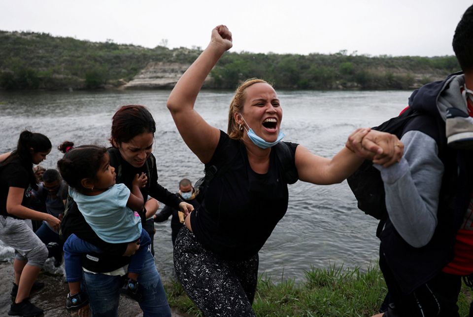 Migrants from Venezuela cross the Rio Grande into Del Rio, Texas, on May 11. (CNS/Reuters/James Breeden)
