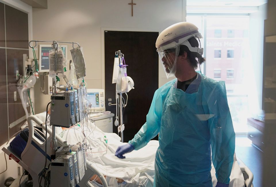 A nurse in Oklahoma City works in a COVID-19 patient's room at SSM Health St. Anthony Hospital's intensive care unit Aug. 24. SSM Health, a Catholic health system, was formerly sponsored by the Franciscan Sisters of Mary. (CNS/Reuters/Nick Oxford)