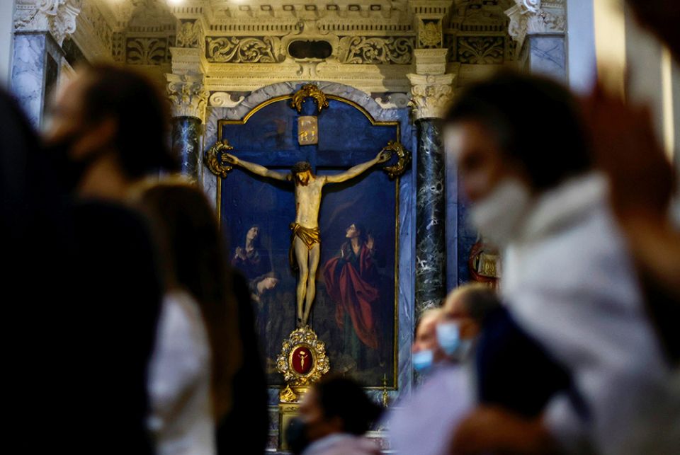 A crucifix is seen as people pray during a Mass at the cathedral Oct. 10 in Nice, France. (CNS/Reuters/Eric Gaillard)