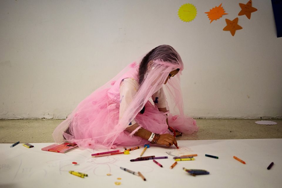 An Afghan child participates in social and emotional art initiatives after being evacuated and arriving at the Philadelphia International Airport in Philadelphia Oct. 25. (CNS/Reuters/Hannah Beier)