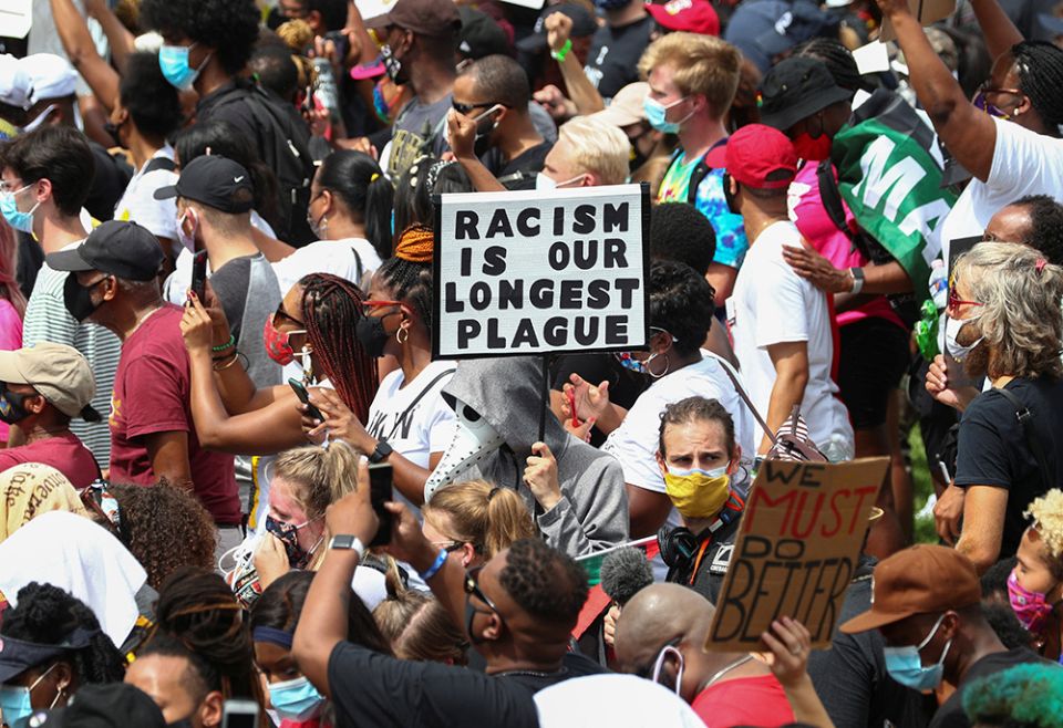 Protesters in Washington stand with a sign reading "Racism is Our Longest Plague" Aug. 28, 2020, at the spot where civil rights leader the Rev. Martin Luther King Jr. delivered his "I Have a Dream" speech. (CNS/Reuters/Tom Brenner) Protesters in Washington stand with a sign reading "Racism is Our Longest Plague" Aug. 28, 2020, at the spot where civil rights leader the Rev. Martin Luther King Jr. delivered his "I Have a Dream" speech. (CNS/Reuters/Tom Brenner)