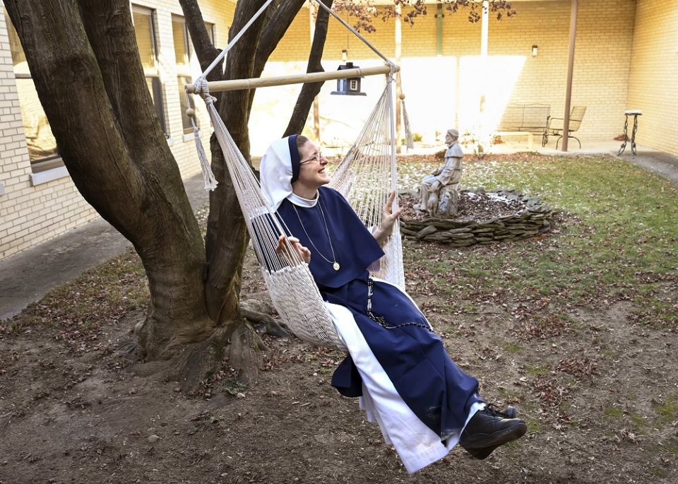 Sister Monica Marie takes a swing in a rope chair Jan. 15 in the courtyard at St. Anthony's Convent of the Sisters of Life in Catskill, New York. (CNS/The Evangelist/Cindy Schultz)
