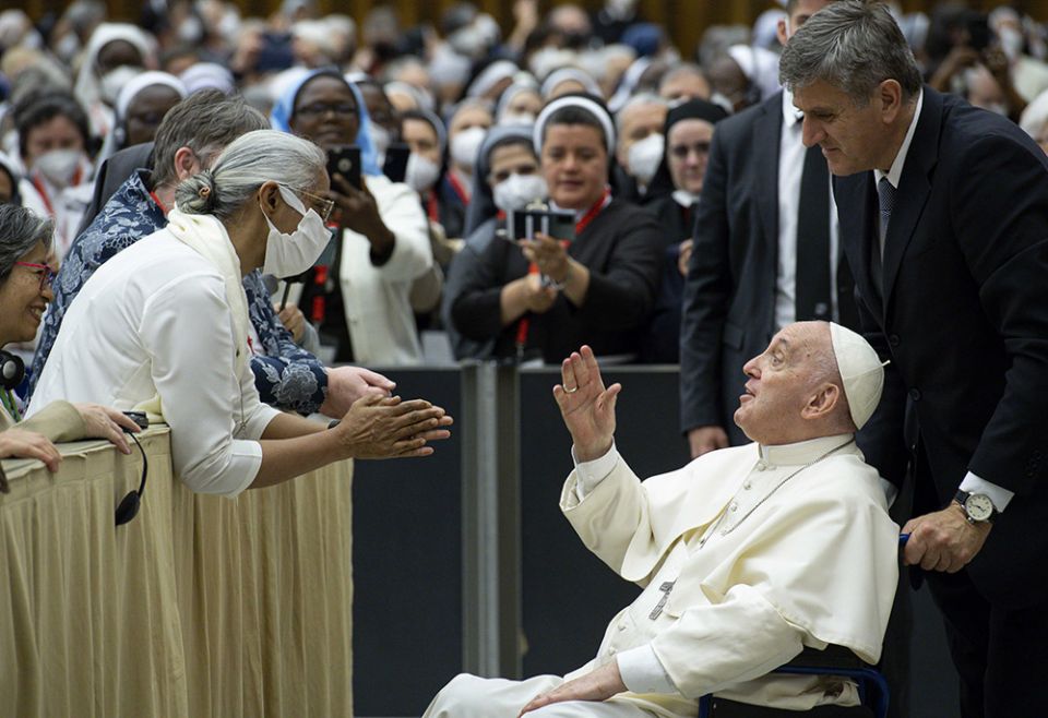 Pope Francis is pushed in a wheelchair by his aide, Sandro Mariotti, as he greets participants May 5 in the plenary assembly of the women's International Union of Superiors General at the Vatican. (CNS/Vatican Media)