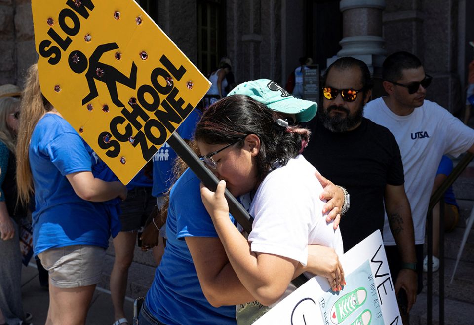 Jazmin Cazares, 17, right, the sister of Jackie Cazares, who was killed in the May 24 mass shooting at Robb Elementary School in Uvalde, Texas, gets a hug from Mary Morales of Kyle, Texas, June 11 during a March for Our Lives rally in Austin, Texas. (CNS)