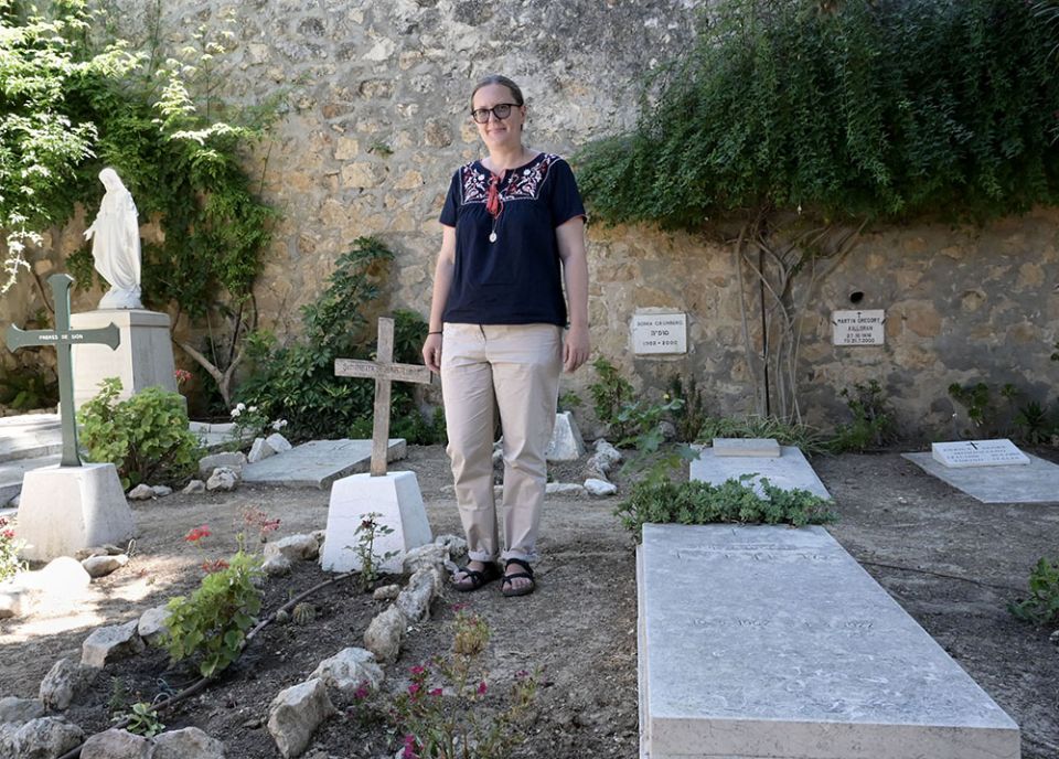 Sr. Kasia Kowalska, a member of Our Lady of Sion from Krakow, Poland, poses July 18 in the cemetery of the Notre Dame de Sion convent in West Jerusalem.