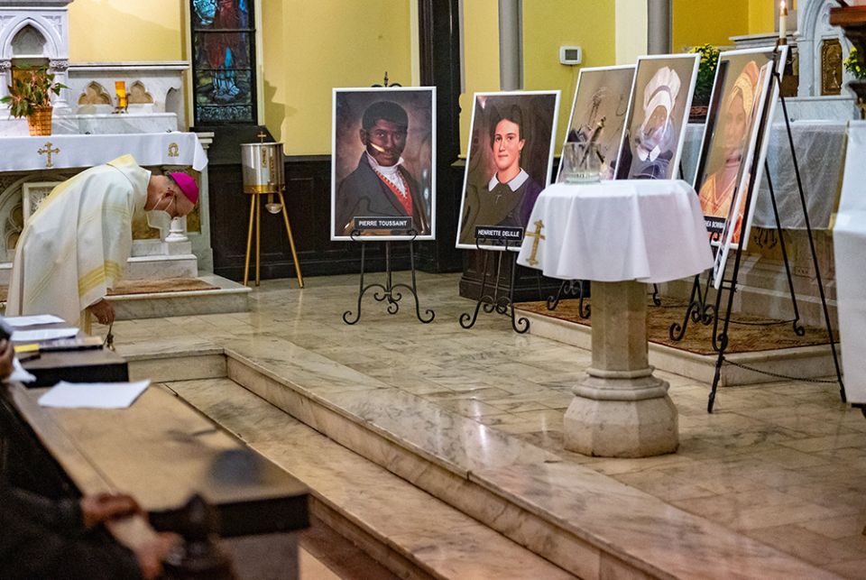 Baltimore Auxiliary Bishop Bruce Lewandowski bows before images of six African Americans who are candidates for sainthood during the All Saints' Day Mass at St. Ann Church Nov. 1 in Baltimore. (CNS/Catholic Review/Kevin J. Parks) Baltimore Auxiliary Bishop Bruce Lewandowski bows before images of six African Americans who are candidates for sainthood during the All Saints' Day Mass at St. Ann Church Nov. 1 in Baltimore. (CNS/Catholic Review/Kevin J. Parks)