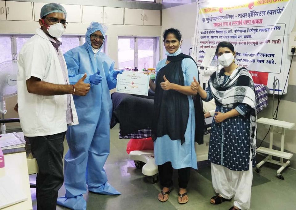 Holy Spirit Sr. Sneha Joseph, second from right, celebrates with hospital staff at Nair hospital after donating her plasma to treat COVID-19 patients in Mumbai. (Provided photo)