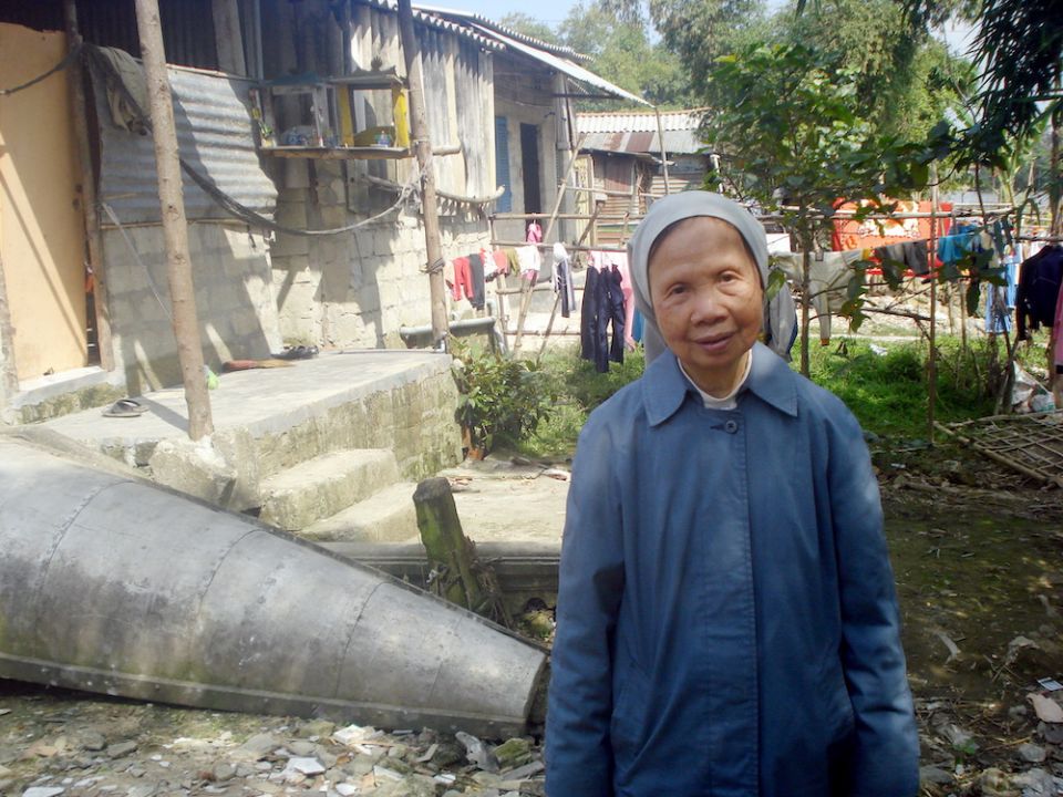 St. Paul de Chartres Sr. Ephrem Nguyen Thi Luu, 76, visits poor families who live on river banks in Hue City. (Peter Nguyen)