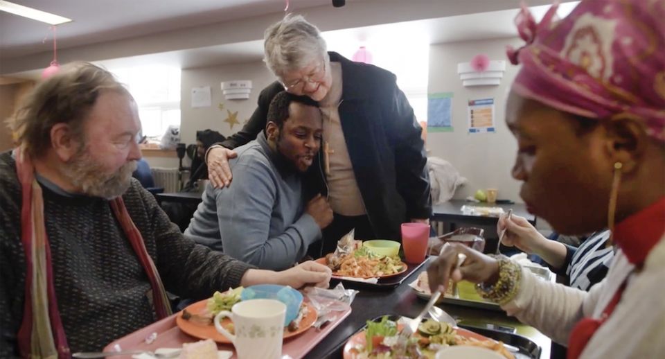 Felician Sr. MaryAnne Olekszyk visits with guests during a meal at St. Felix Centre in Toronto, Ontario, before the coronavirus pandemic. (Courtesy of St. Felix Centre, Felician Sisters of North America/Elliott Cramer) 