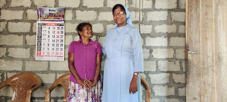 Sr. Dulcie Fernando, former provincial of the Salvatorians in Sri Lanka, with the owner of one of the first houses built in 2015, when the Salvatorians started building homes for homeless people in Sri Lanka. (Thomas Scaria)