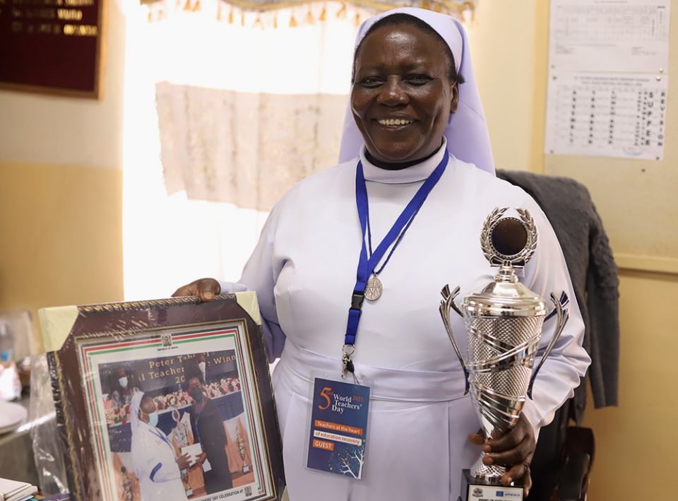 Sr. Anne Onyancha, a member of the Sisters of Mary of Kakamega and head teacher of St Peter's Mumias Boys Primary School in Kakamega, Kenya, displays the trophy she was awarded for ensuring quality education in Kenya. (GSR photo/Doreen Ajiambo)