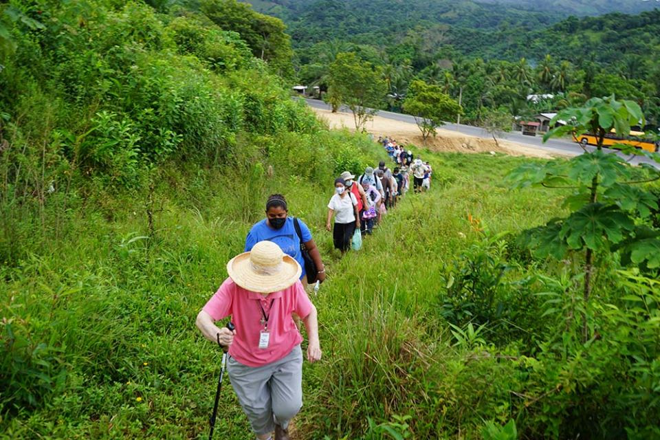 A 24-person delegation to Honduras organized by the SHARE Foundation begins to climb up a hillside to visit with the El Aguacate community.