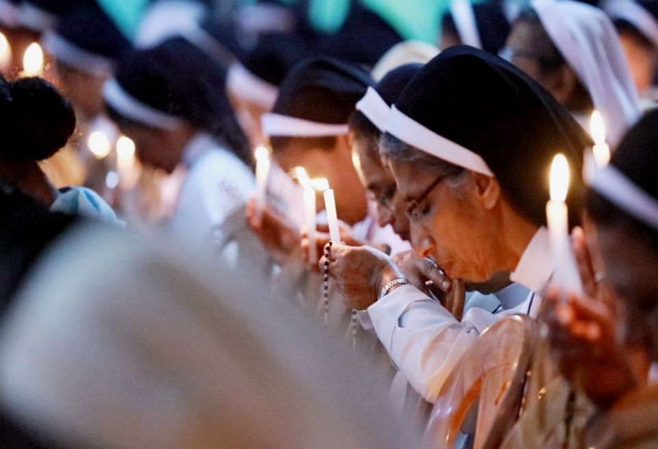 Catholic nuns with lighted candles pray at the adoration of the Blessed Sacrament in support of religious life at the Pastoral Centre of Dwaraka parish in the Mananthavady Diocese in Kerala, southern India. (Saji Thomas)