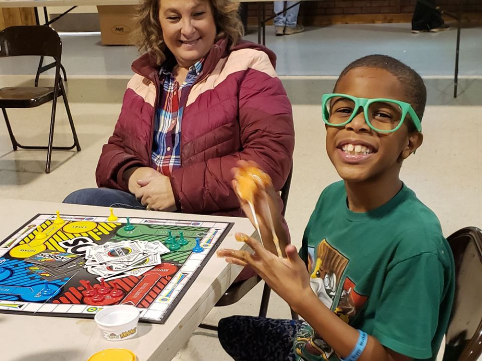 Shane, age 7, enjoys some attention two days after his family lost everything when the tornado swept through Graves County, Kentucky, on Dec. 10, 2021. He claimed the green sunglasses to help him cope and created a fun exchange with our volunteers.