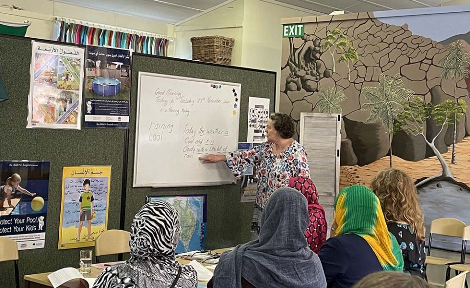 Volunteer Monica Byrnes leads a language class for women refugees at Zara's House. (Tracey Edstein)