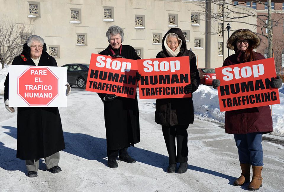 From left, Notre Dame de Namur Sr. Mary Jane Cavallo, Medical Missionaries of Mary Srs. Nina Underwood and Margaret Meyer, and a member of the public participate in a January 2019 prayer vigil honoring National Human Trafficking Prevention Month.