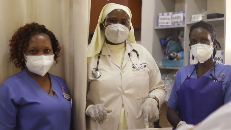Sr. Assumpta Nabawanuka, center, and two nurses visit patients admitted at St. Francis Hospital Nsambya in Kampala, Uganda's capital. Nabawanuka is a member of the Sisters of the Immaculate Heart of Mary Reparatrix – Ggogonya.