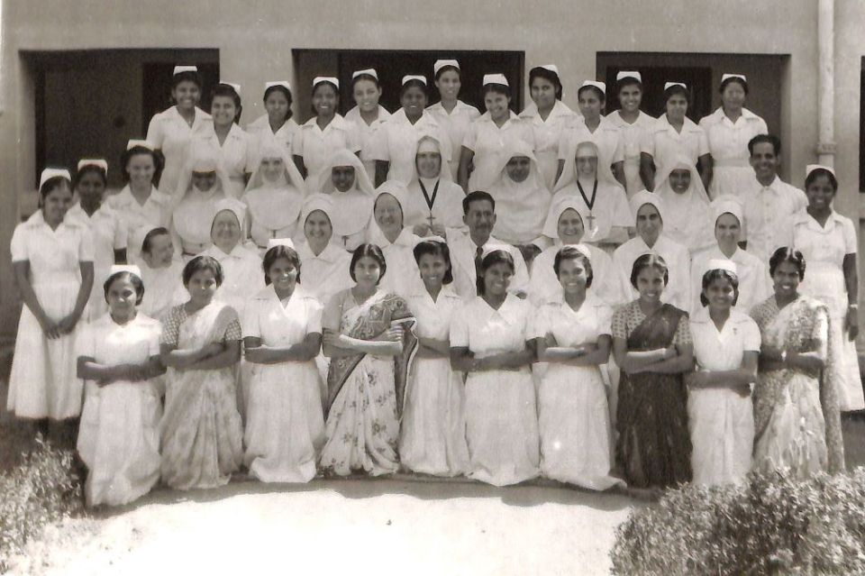 Members of the faculty and student body of the newly opened school of nursing at Nazareth Hospital in Mokama, India, in October 1953. The students are a mix of Indian women and nuns from other orders, pictured in full white veils and wimples.