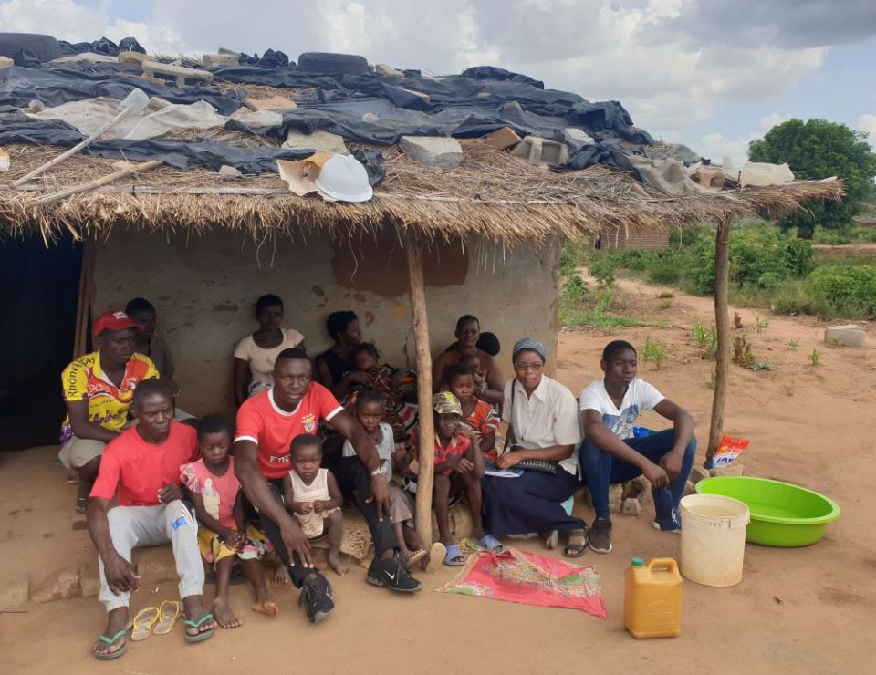 Good Shepherd Sr. Eva Ribeiro, in white blouse, and project manager Pirai Oriente, in red T-shirt with white trim, work with displaced families from Cabo Delgado province, Mozambique. (Courtesy of Eva Ribeiro)