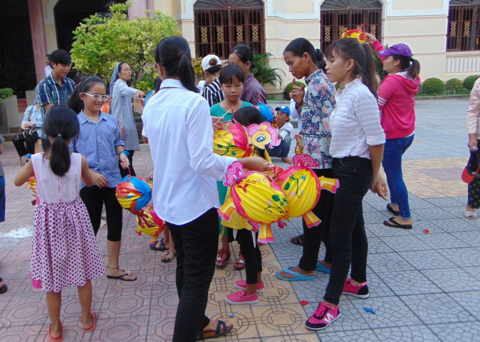 Sisters of St. Paul de Chartres offer food and colorful lanterns to 50 children in Hue whose families live on boats Sept. 7. Many of the children drop out of school and sell food in the streets for a living. (GSR photo/Joachim Pham) 
