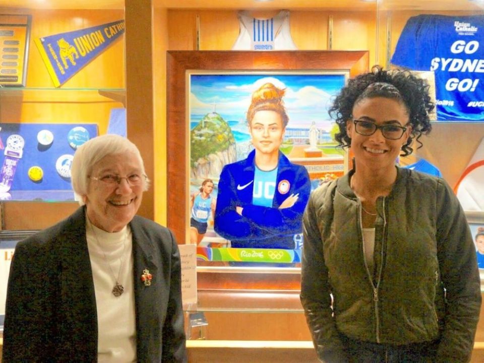 Mercy Sr. Percylee Hart, left, stands with gold medalist Sydney McLaughlin during the December 2017 dedication of the trophy case honoring the Union Catholic Regional High School track alumna. (Courtesy of Jim Lambert)