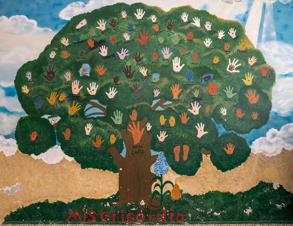 Hands of orphaned children populate the family tree at Casa Corazón de la Misericordia with principal "Mama" Laura Donaire as the base. (Gregg Brekke)