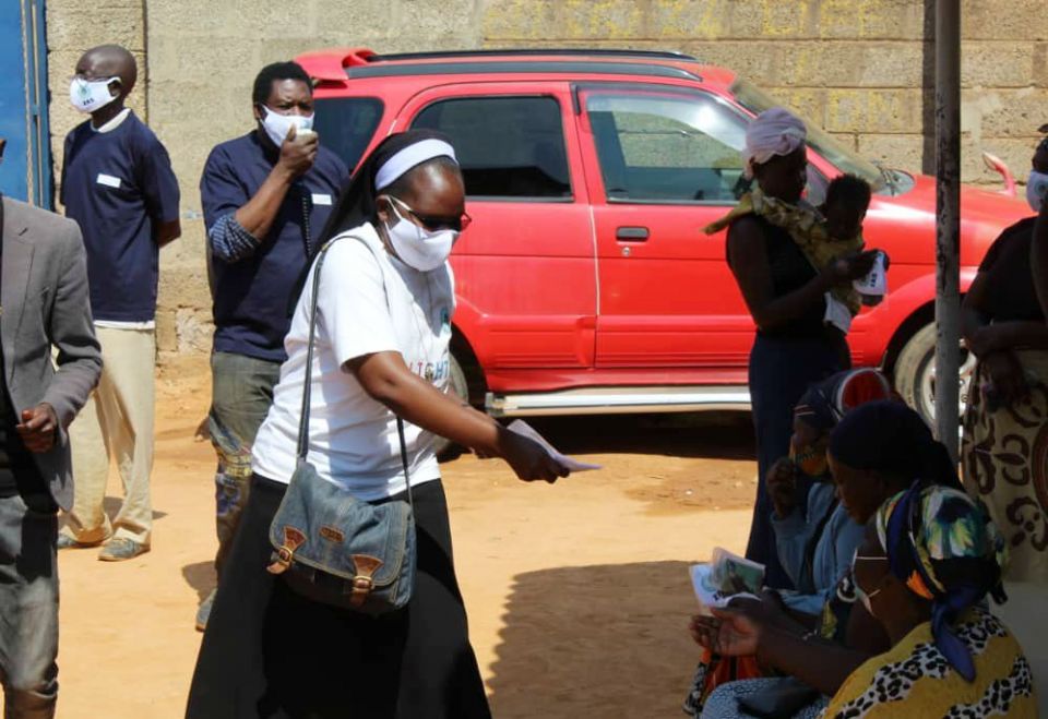 Sr. Astridah Banda and community health workers distribute facemasks to residents in Zambia and talk with them about COVID-19. Banda started a radio show called "COVID-19 Awareness Program," which focuses on defusing misinformation about the pandemic. Sr. Astridah Banda and community health workers distribute facemasks to residents in Zambia and talk with them about COVID-19. Banda started a radio show called "COVID-19 Awareness Program," which focuses on defusing misinformation about the pandemic.