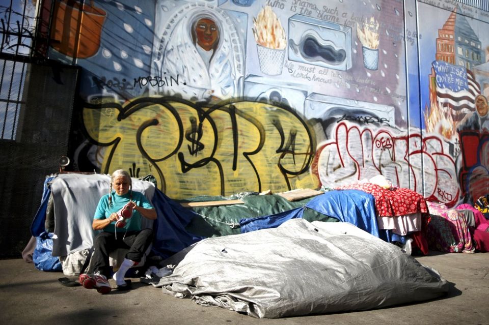 A woman sits outside her tent on Skid Row in downtown Los Angeles in 2015. (CNS/Reuters/Lucy Nicholson)