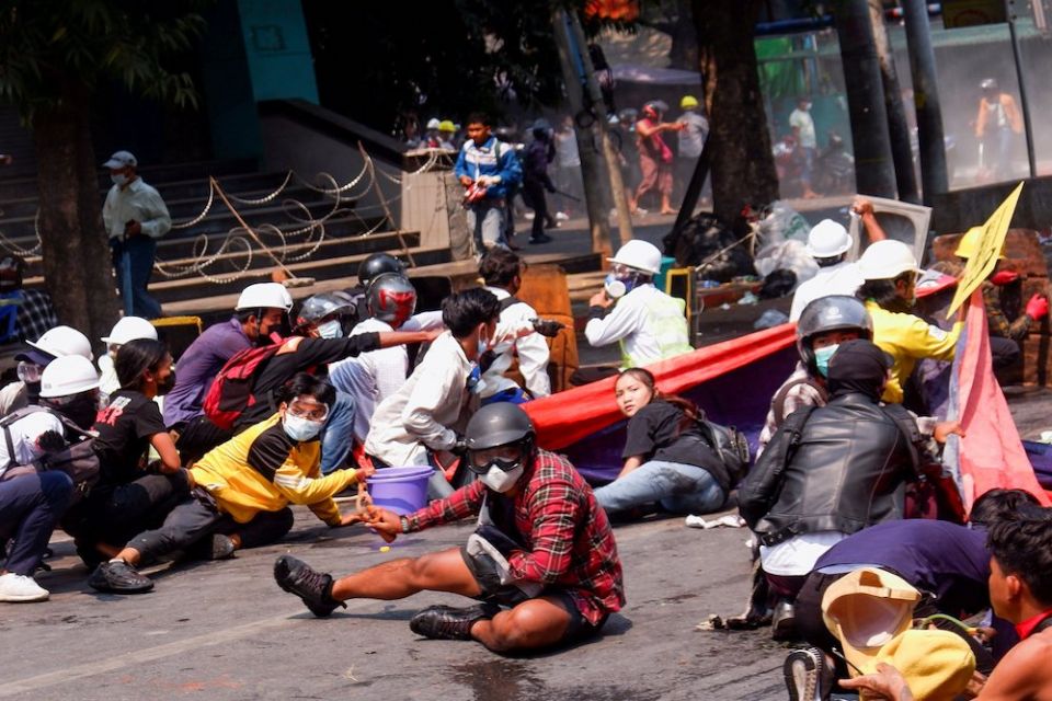 Demonstrators crouch after police opened fire to disperse an anti-coup protest in Mandalay, Myanmar, March 3, 2021. (CNS/Reuters)