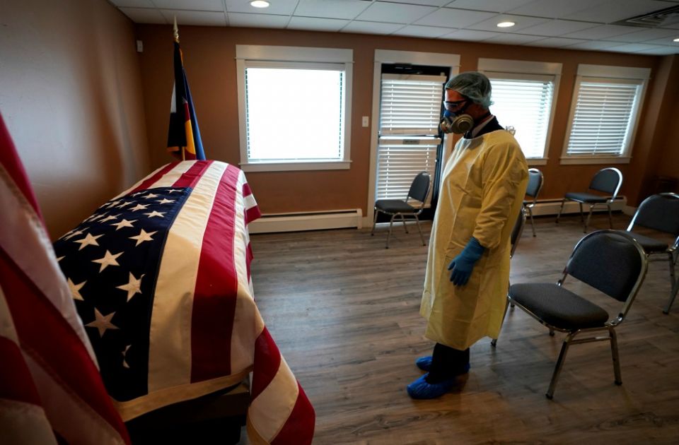 On April 23, Michael Neel, funeral director of All Veterans Funeral and Cremation in Denver, looks at the casket of George Trefren, a 90-year-old Korean War veteran who died of the coronavirus in a nursing home. (CNS / Reuters / Rick Wilking) On April 23, Michael Neel, funeral director of All Veterans Funeral and Cremation in Denver, looks at the casket of George Trefren, a 90-year-old Korean War veteran who died of the coronavirus in a nursing home. (CNS / Reuters / Rick Wilking)