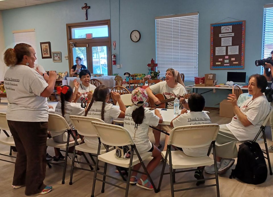 Teresian Sr. Clarice Suchy plays the guitar for Camp I-CAN participants and volunteers July 26. (Courtesy of Dolores Aviles)