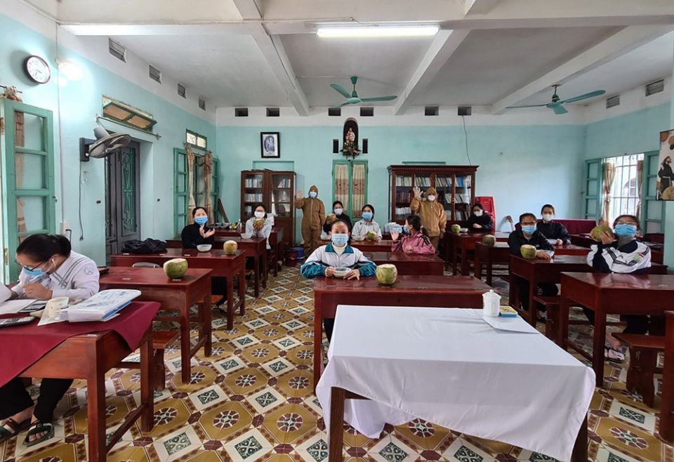 Daughters of Our Lady of the Holy Rosary of Bui Chu who have minor COVID-19 symptoms receive coconut juice in one of the classrooms at the motherhouse in Xuan Truong district, Nam Dinh province. (Daughters of Our Lady of the Holy Rosary of Bui Chu)