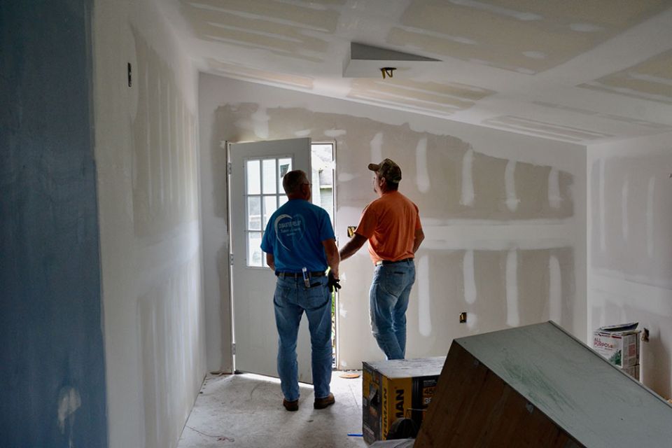 David White, left, and Ronnie Mattingly check out a leaky door May 23 at a house in Mayfield, Kentucky, damaged by a tornado in December. (GSR photo/Dan Stockman)