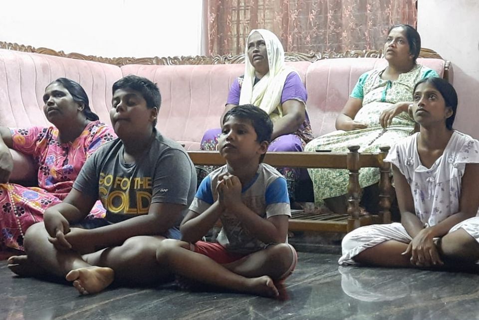 A family prays during a Home Mission visit, an intercongregational project in the Latin Archdiocese of Trivandrum. (Courtesy of Felcy Mangalath)